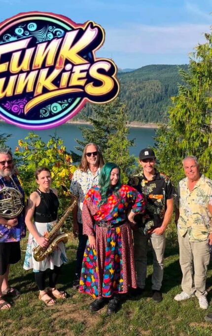 Seven people stand outdoors with musical instruments in front of a scenic lake and forest backdrop. A colorful "Funk Junkies" logo appears above them. The group wears casual and colorful clothing.
