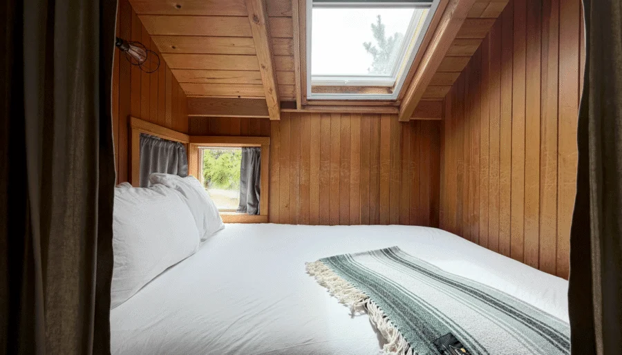 Cosy Captain King bedroom with skylight and plush bed, showcasing serene nature views and tranquil retreat vibes.