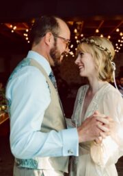 Couples enjoy a romantic dance in a warmly lit hotel's elegant event space, featuring soft lighting and festive decor.
