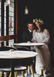 Cosy hotel lounge with couple, stained glass, stylish decor.