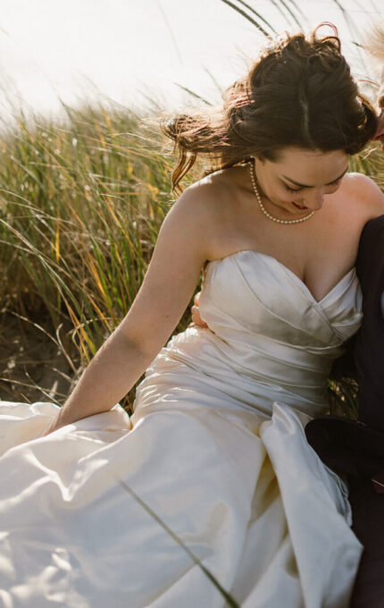 Couple enjoying a romantic moment in a field, highlighting serene ambience of nearby hotel gardens.