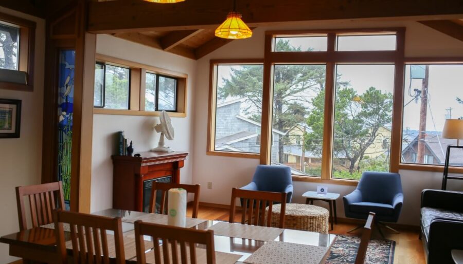 Cosy hotel lounge with scenic forest views, plush seating, warm lighting, and rustic wooden accents.